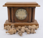 An American hardwood mantel clock case of architectural form with full and split columns, wax card dial and Arabic numerals (movement missing), early 20th century; together with a box of turned beech wood Vienna wall clock finials, (17 finials). The clock