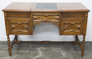 THE LYNCOMBE Model R4 gramophone and record holder in the form of a Tudor style desk, English oak with tooled leather top, circa 1925, 78cm high, 125cm wide, 56cm deep