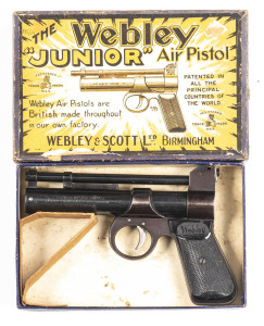 WEBLEY JUNIOR AIR PISTOL: 177 Cal; s/shot; 153mm (6") barrel; exc bore; standard sights & fittings; retaining 90% original blue finish with most losses to the grip frame; vg Webley black plastic grips; gwo vg cond. In its original Webley orange & black c