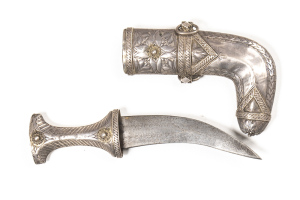 OMANI SILVER MOUNTED JAMBIYA: 6" curved double edged blade with v. light staining; ornate silver hilt with Islamic script & filigree work; silver mounted scabbard with foliage panels; vg cond. Jambiya is only 9" o/a; possibly for a boy. C.1860 L/