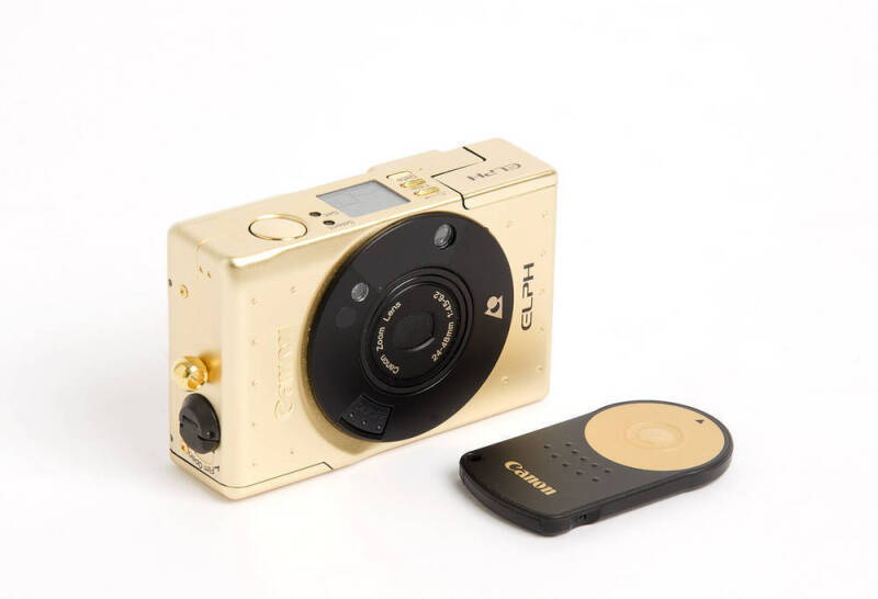 CANON: Elph IXUS 18k gold-plated Limited Edition complete kit (with documentation) [#002063] in velvet-lined timber case. Issued in 1997 to commemorate the 60th anniversary of the Canon Company.