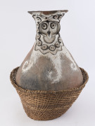 An impressive sago pot, decorated and fired clay with woven basket stand, Aibom village, Chambri Lakes, Papua New Guinea, circa 1960, ​66cm high overall - 2