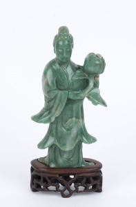 A Chinese carved statue of Guanyin holding a lotus, on pierced carved rosewood stand, 19th/20th century, 21cm high
