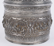 A stunning antique Burmese silver ceremonial betel box. Decorated with six deep repoussé cartouches showing Burmese mythological scenes with lotus and scroll frieze. The lid also beautifully worked in repoussé with seven further figural vignettes and a sp - 4