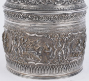 A stunning antique Burmese silver ceremonial betel box. Decorated with six deep repoussé cartouches showing Burmese mythological scenes with lotus and scroll frieze. The lid also beautifully worked in repoussé with seven further figural vignettes and a sp - 5