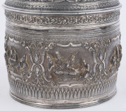 A stunning antique Burmese silver ceremonial betel box. Decorated with six deep repoussé cartouches showing Burmese mythological scenes with lotus and scroll frieze. The lid also beautifully worked in repoussé with seven further figural vignettes and a sp - 7