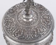 A stunning antique Burmese silver ceremonial betel box. Decorated with six deep repoussé cartouches showing Burmese mythological scenes with lotus and scroll frieze. The lid also beautifully worked in repoussé with seven further figural vignettes and a sp - 8