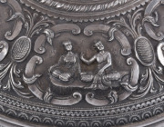 A stunning antique Burmese silver ceremonial betel box. Decorated with six deep repoussé cartouches showing Burmese mythological scenes with lotus and scroll frieze. The lid also beautifully worked in repoussé with seven further figural vignettes and a sp - 13