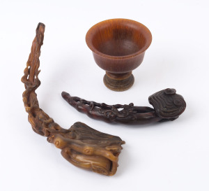 A carved horn wine cup, (19th century); together with a carved horn Ruyi sceptre with mushroom finial and Chi-Long dragon handle (19th century; as well as a carved horn sceptre adorned with leaves and peaches, (19th century), (3 items), the cup 9cm high, 