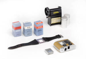 CONCAVA (Switzerland): Tessina miniature 35mm automatic camera in gold [#665117], with slip-on meter, brown leather case with gold trim, maker's box, wrist strap and 2 cassettes, Tessina daylight loader in original plastic case. Also, 3 boxes of Kodak fil