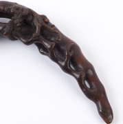 A carved horn wine cup, (19th century); together with a carved horn Ruyi sceptre with mushroom finial and Chi-Long dragon handle (19th century; as well as a carved horn sceptre adorned with leaves and peaches, (19th century), (3 items), the cup 9cm high, - 12