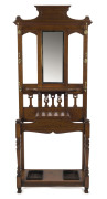 An antique English oak hallstand with bevelled mirror back and lift-top storage compartment, early 20th century, ​203cm high, 84cm wide, 28cm deep