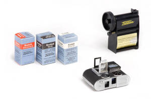 CONCAVA (Switzerland): Tessina L 35mm miniature camera in black [#965087], with instructions, pop-up finder, slip-on meter with instructions, black leather case, tripod plate with chain and Tessina daylight Loader in original plastic case.