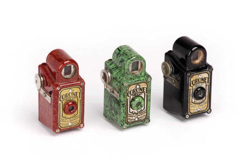 CORONET CAMERA CO. (England): c1935 Midget 16mm bakelite cameras in red, green and black. (3 cameras).