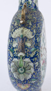 An impressive Chinese porcelain moon-flask vase decorated with two circular famille rose panels with pheasants and flowers in landscape, adorned with gilt dragon handles, and intricate scrolling floral border on blue ground, Daoguang period, Qing Dynasty, - 7