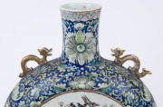 An impressive Chinese porcelain moon-flask vase decorated with two circular famille rose panels with pheasants and flowers in landscape, adorned with gilt dragon handles, and intricate scrolling floral border on blue ground, Daoguang period, Qing Dynasty, - 8