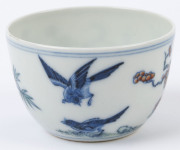 Two Chinese porcelain teacups with Doucai decoration with birds and blossoms in landscape, 19th/20th century, Yongzheng underglaze blue six character mark, 4cm high - 5