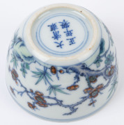 Two Chinese porcelain teacups with Doucai decoration with birds and blossoms in landscape, 19th/20th century, Yongzheng underglaze blue six character mark, 4cm high - 6