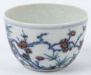 Two Chinese porcelain teacups with Doucai decoration with birds and blossoms in landscape, 19th/20th century, Yongzheng underglaze blue six character mark, 4cm high - 8