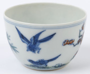 Two Chinese porcelain teacups with Doucai decoration with birds and blossoms in landscape, 19th/20th century, Yongzheng underglaze blue six character mark, 4cm high - 10