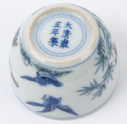 Two Chinese porcelain teacups with Doucai decoration with birds and blossoms in landscape, 19th/20th century, Yongzheng underglaze blue six character mark, 4cm high - 12