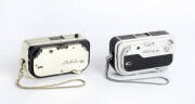 FEINWERKTECHNIK (Germany): Sub-miniature cameras for 10x14 exposures on 16mm film in cassettes: Mec-16, 1958 [#6590377 - gold] with Color-Ennit f2.8 20mm lens; and, Mec-16 SB, 1960 [#3600050], with Rodenstock Heligon f2 22mm lens. Both cameras in presenta