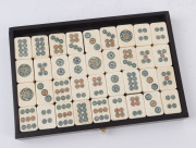 A Chinese marine ivory and bone Mah-jong set in a hardwood table cabinet with a sliding door opening to reveal five drawers with a complete set of hand painted pieces. The hardwood box has double bronze handles. Chinese character marks with the original o - 5