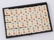 A Chinese marine ivory and bone Mah-jong set in a hardwood table cabinet with a sliding door opening to reveal five drawers with a complete set of hand painted pieces. The hardwood box has double bronze handles. Chinese character marks with the original o - 7
