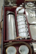 A stunning early automotive picnic set by "EDWARDS & SONS, REGENT STREET, LONDON", early 20th century, comprising stainless steel, enamel and silver plated cutlery, cannisters, warmers, containers etc., the case 62cm wide - 9