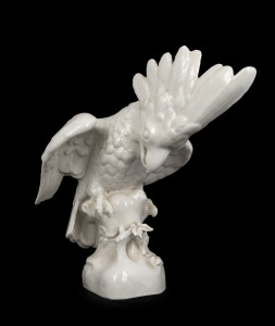 An antique white porcelain statue of a cockatoo, Austrian or German, 19th century, impressed marks to base (illegible), 33cm high, 35cm wide