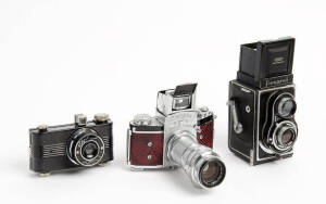 IHAGEE KAMERAWERK (Germany): Exakta Varex VX, 1951-53 [#734772] 35mm SLR with prism finder, snake-skin leather covering and Biotar f2, 58mm lens on extension tubes. Also, a MEOPTA Flexaret TLR and an ELGIN Miniature. (3 cameras).