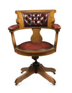 An Australian blackwood revolving desk chair with red leather upholstery, late 19th century, ex Public Works Department, Melbourne, 69cm across the arms
