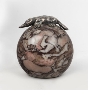 An Australian paperweight, spherical marble with applied silver platypus, 20th century, stamped "STG. SIL. M. HAMMOND", ​9cm high