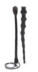 Two Australian police coshes, one with steel bar and weighted interior covered with animal tail leather hide, the second with a spiral whale baleen shaft with lead filled and woven bulb ends, with leather wrist strap, late 19th century, the largest 34cm long