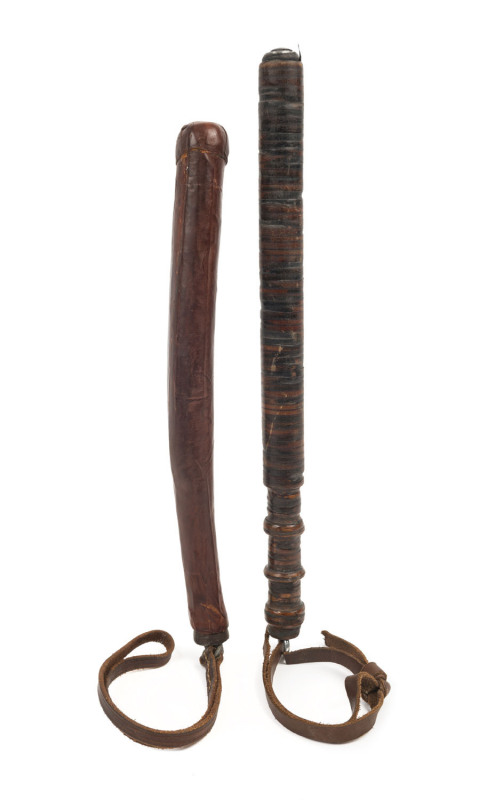 Two Australian truncheons, one South Australian maroon leather covered with steel shaft and leather wrist strap, the other compressed leather disc construction with steel shaft interior and leather wrist strap, 20th century, the larger 42cm long,