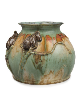 REMUED pottery vase with two applied koalas perched on branches with gumnuts and gum leaves, circa 1933, rare orange and green colourway with blue interior (previously unrecorded, possibly a prototype), incised "Remued, Handmade" with pencil inscription "50B, MB/J", 17cm high, 21cm wide