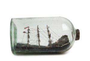 An antique ship in a bottle with coastal scene diorama, 19th century, 20cm long