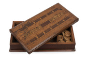 An Australian games box with cribbage top and fold-over chess board, silky oak, cedar, Queensland walnut and pollard oak, 19th century, with accompanying draughts pieces and three carved whale bone dice, ​8.5cm high, 31cm wide, 15.5cm deep