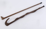 An antique Australian fiddleback blackwood walking stick with boot handle; together with an Aboriginal carved snake example, ​19th and 20th century, (2 items) 89cm and 82cm high - 2