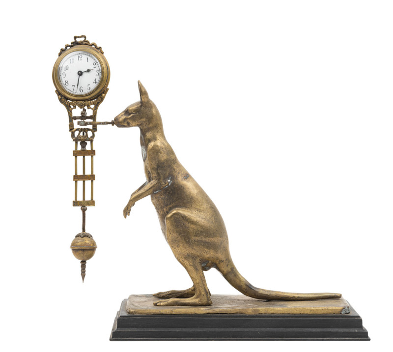 KANGAROO mystery clock with 8 day swinging pendulum movement and enamel dial with Arabic numerals, standing on an ebonized timber plinth, early 20th century. ​29cm high.