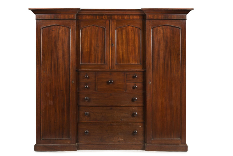 A fine Colonial Beaconsfield gentleman's wardrobe with inverted breakfront, Australian cedar with huon pine secondary timbers and blackwood knobs, Tasmanian origin, circa 1850. Bearing label on the back "A. JONES, LAUNCESTON". 203cm high, 220cm wide, 70cm