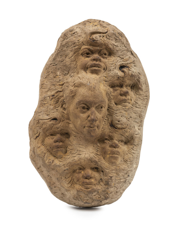 WILLIAM RICKETTS self portrait pottery wall plaque depicting William Ricketts surrounded by Aboriginal faces, incised "Wm. Ricketts,", ​26cm high