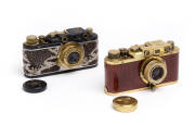 LEICA (Fake): Attractive but strange gold-metal and polished timber Leica II camera [#10518, which would be a 1928 manufacture, if correct!] with fake Elmar f3.5 50mm lens together with an eagle & swastika engraved lens cap. Also, a grey-metal, brass and 