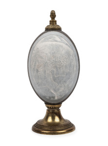 An emu egg ornament carved with lyrebirds in forest landscape, silver plated mounts polished back to brass, Victorian origin, late 19th century, 20.5cm high
