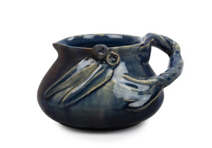 REMUED early blue glazed pottery jug with applied gumnuts, leaves and branch handled, incised "Remued", 7cm high, 14cm wide