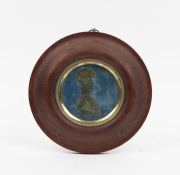 An antique Australian circular picture frame, red gum with original gilt slip, glass and blue silk backing, mid 19th century, 20.5cm diameter overall, 9.5cm internal diameter