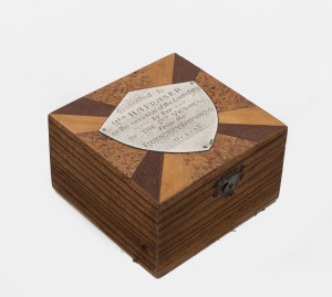 A specimen wood jewellery box with Australian silver plaque "Presented To Mrs H. A. Fraser On The Occasion Of The Launching By Her Of The 1st Vessel From the Footscray Shipyards. 11-09-43", 6cm high, 10.5cm wide, 10cm deep