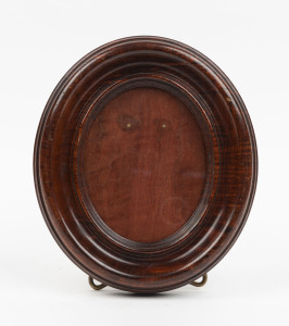 An Australian fiddleback blackwood oval picture frame with folding brass stand, late 19th century, ​20.5cm high