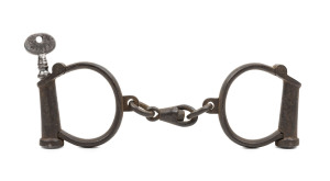 HIATT antique handcuffs with broad arrow mark, stamped "Hiatt, Warranted, Wrought, Hard", No.6, with original key stamped "HIATT No.22", 23cm wide