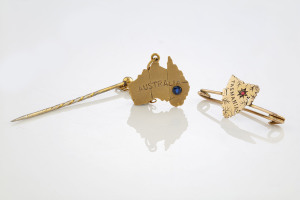 An antique 9ct gold and ruby map of Tasmania brooch together with a 9ct gold map of Australia stick pin (2 items), circa 1900, 3.9 grams total